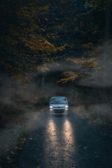 Foreste Casentinesi National Park, Badia Prataglia, Tuscany, Italy, Europe. Car comes out from foggy wood.