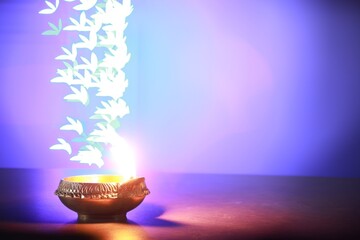 Diwali celebration. Diya lamp on color background, space for text