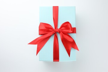Beautiful gift box with red bow isolated on white, top view
