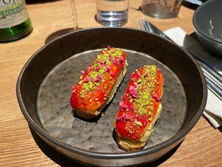 Eclairs stuffed with pate in cast-iron dishes.