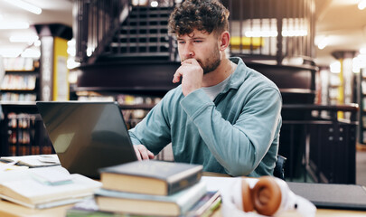 University, laptop and thinking with man in library for knowledge, education and college thesis....