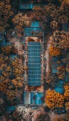 Aerial view of solar panels on a rooftop surrounded by trees.