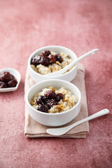 Homemade pudding with warm cherries and coconut