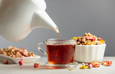 Herbal tea is poured into a mug.