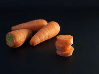 carrots. some carrots on a black background	
