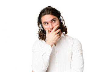 Telemarketer man working with a headset over isolated chroma key background having doubts and with confuse face expression
