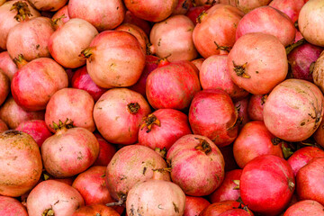 Many pomegranates for sale at the market. Fruit background