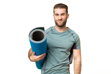 Young sport man going to yoga classes while holding a mat over isolated chroma key background with sad expression