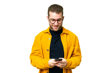 Young handsome blonde man over isolated chroma key background sending a message with the mobile