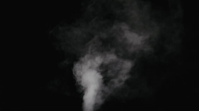 Slow motion water mist stream with wind effect over black background