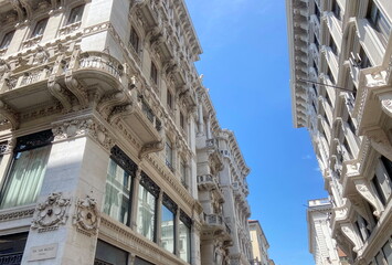 A view of the streets of the business center of modern Trieste surrounded by buildings of...