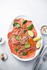 Beef carpaccio with lime and spinach