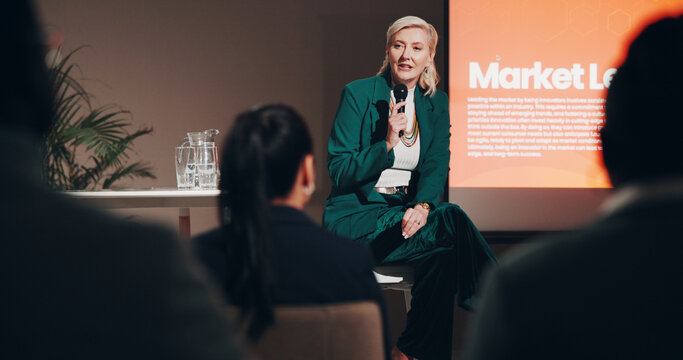 Mature woman, stage and seminar with microphone for leadership skills, information or knowledge. Female person, public speaker and presentation at global summit, conference or motivation in uplifting