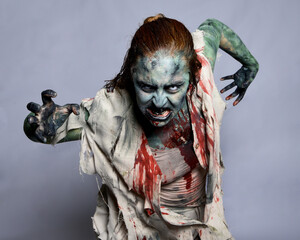 Close up portrait of scary female model wearing spooky halloween costume, ripped apocalyptic...