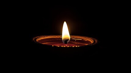 A close-up image of a single candle flame glowing brightly against a dark background, creating a peaceful and serene atmosphere.