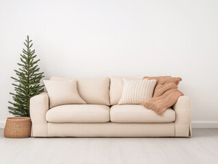 Cozy living room setup with a neutral sofa, decorative pillows, and a Christmas tree