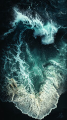 a teal and blue sapphire wave crashes onto a dark, black sandy beach, captured from a bird's eye view. The wave is moving upwards