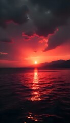 Fototapeta premium Fiery Sunset over Calm Sea: A breathtaking sunset paints the sky and sea in vibrant hues of fiery red and deep orange, as the sun dips below the horizon.