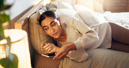 Fototapeta premium Relax, calm and woman on bed in home preparing for afternoon nap on weekend with peace. Lamp, rest and young female person getting ready for day time sleeping in bedroom for break in apartment.