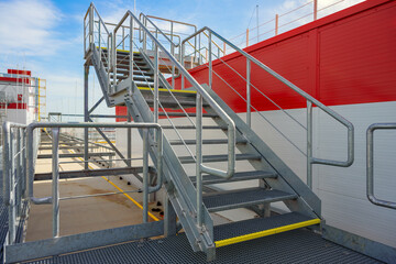 Steel galvanized access service stairs on the roof of industrial building