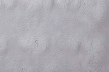 Fototapeta premium A close-up view of soft, fluffy fur texture. The fur appears smooth and wavy, creating a gentle, flowing pattern that adds depth and softness to the image.