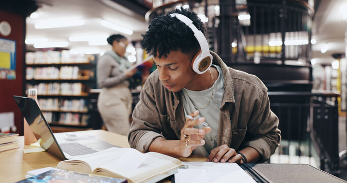Music, book and research with man in library for knowledge, education and college thesis. Headphones, future and university with student and studying on campus for exam, project and scholarship