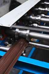 Rolled metal, metal processing and manufacturing of metal fence, close-up of metal rolling equipment at the factory