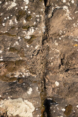 Natural weather effect brown rock texture with cracks, Close-up of Rough mountain surface background for design,backdrop
