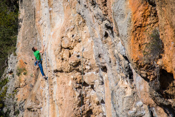 A rock climber ascends to the summit via a difficult route.