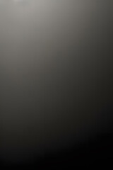 A smooth, dark gradient background with subtle variations in tone, creating a sense of depth and texture. Ideal for use as a backdrop in design projects or presentations.