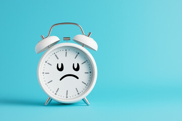 Alarm clock with sad face on empty background. Minimal creative concept of Blue Monday