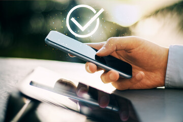 Hand holding smartphone with checkmark symbol indicating approval or success.