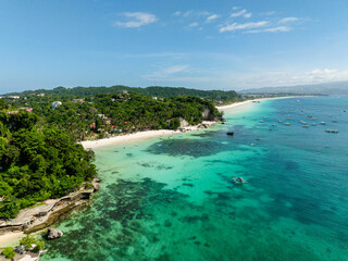 Diniwid Beach with coconuts trees, white sands and boats over turquoise sea water. Boracay,...