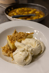 Cheese cake, bananas, caramel dessert. Making dessert behind the scenes. Vanilla Ice cream, whip cream topped on cheese cake, banana sauce topping with caramel on top. 