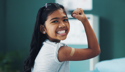 Child, girl and strong in portrait with plaster for vaccine shot, injection and immunization at...