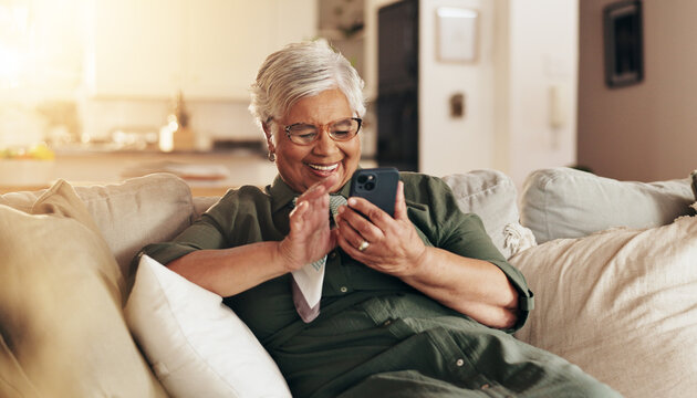 Old woman, relax and phone for communication in home, reading notification and texting on app. Female person, senior lady and couch for scroll on social media, funny ebook and website for news update