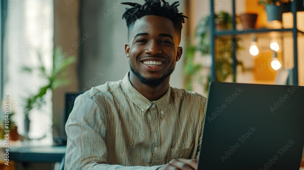 Poster a person smiling while working on a laptop, possibly at home or in an office