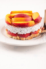 Overnight chia pudding dessert with greek yogurt, peaches and jam