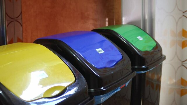 Recycle bins with hand dropping paper slider shot