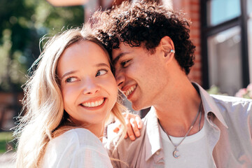 Smiling beautiful woman and her handsome boyfriend. Woman in casual summer clothes. Happy cheerful family. Female having fun. Couple posing in the street it sunny day. Cheerful and happy