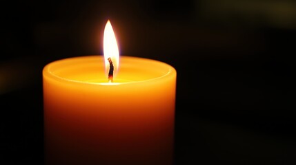 Warm Candlelight on a Single Candle Against a Dark Background with Copy Space for Text or Design