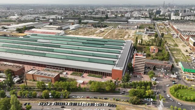 Drone footage of a large factory equipped with solar panels, highlighting sustainable energy solutions and industrial innovation, perfect for environmental and industrial projects.