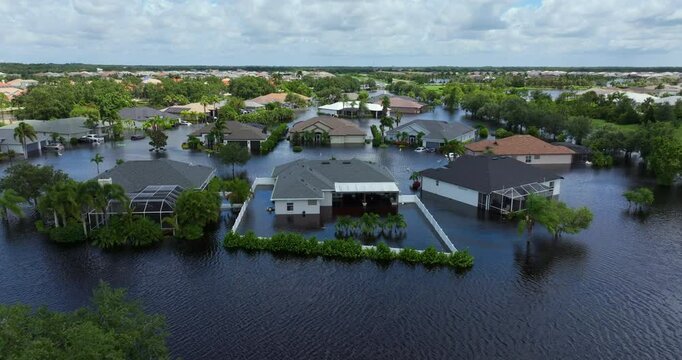 Flooding in Florida caused by tropical storm from hurricane rainfall. Suburb houses in residential community surrounded by flood waters. Aftermath of natural disaster