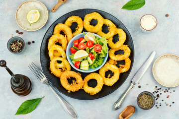 Delicious golden calamari served with fresh salad.