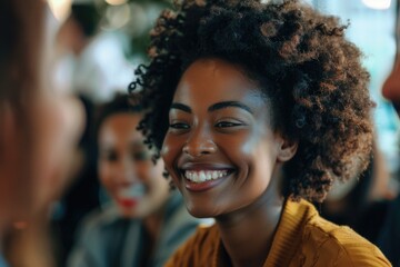 Fototapeta premium A happy woman with curly hair smiling at someone, possibly a friend or loved one