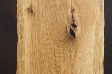 Detail of modern luxury table made of oak and epoxy, surface treated with wax.  Handmade wooden table and black epoxy resin, flat lay.