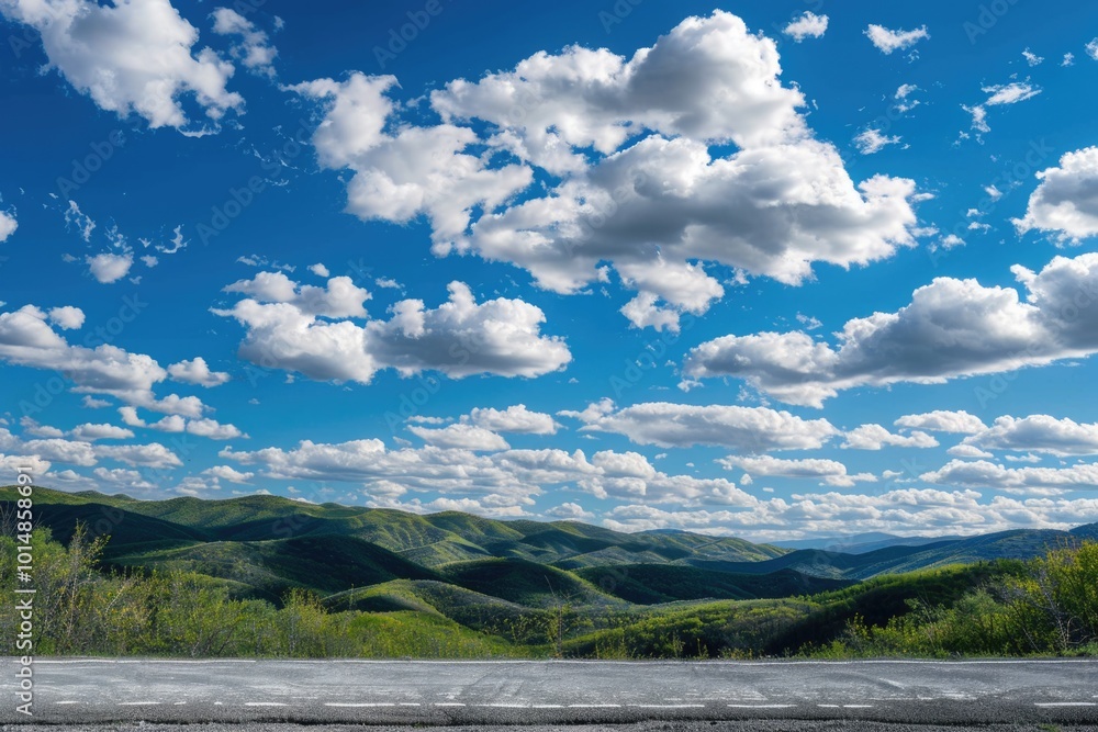 Poster a mountain range with clouds in the sky, suitable for use as a background or landscape image