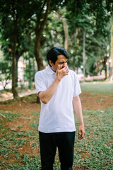 Southeast Asian man covering his mouth, expressing surprise, shock, or silence