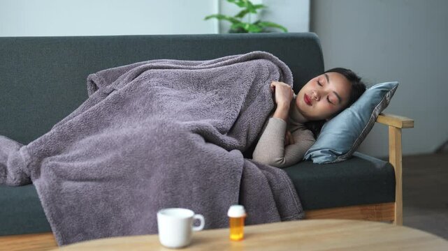 Sick young woman taking medicine at home