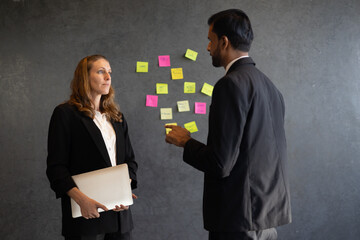 Businessman and businesswoman using problem-solving strategy, showcasing collaboration and success...